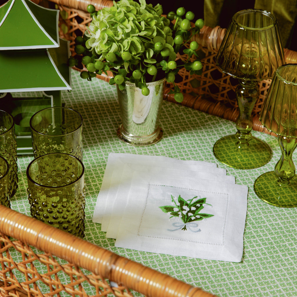 Enhance your table setting with the timeless charm of Lily of the Valley White Linen Cocktail Napkins.
